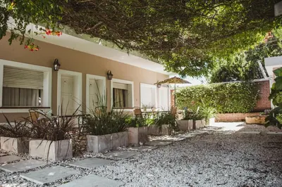 a house with a pathway in front of it at Hotel Gloria in Santa Rosa de Calamuchita