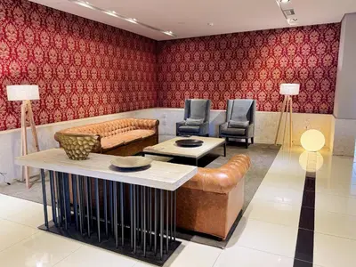 a living room with a couch and two chairs at Amérian Carlos Paz in Villa Carlos Paz