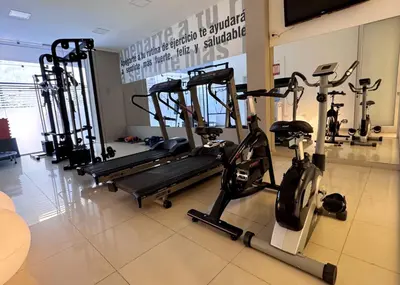 a gym with several tread machines in a room at Amérian Carlos Paz in Villa Carlos Paz