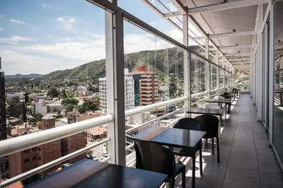 a view from the balcony of a restaurant with tables and chairs at Amérian Carlos Paz in Villa Carlos Paz