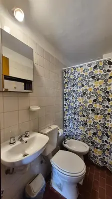 a bathroom with a white toilet and a sink at M772- Departamento temporal in Cordoba