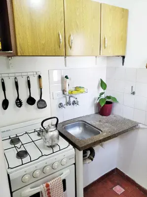 a kitchen with a stove and a sink at M772- Departamento temporal in Cordoba
