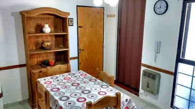 a room with a table and a shelf and a clock at M772- Departamento temporal in Cordoba