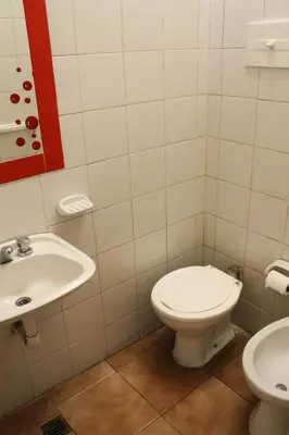 a bathroom with a toilet and a sink at Casi Guemes Hotel in Cordoba