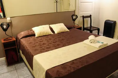 a bedroom with a bed with a towel on it at Casi Guemes Hotel in Cordoba
