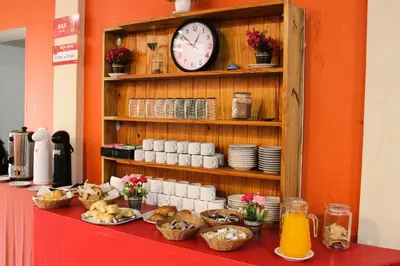 a table with food and a clock on a shelf at Casi Guemes Hotel in Cordoba