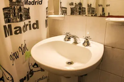 a bathroom with a white sink and a mirror at Casi Guemes Hotel in Cordoba