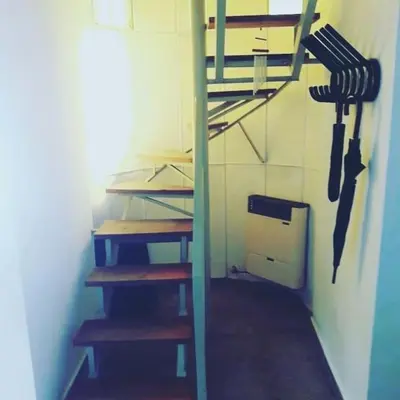 a room with a kitchen with shelves and a refrigerator at DUPLEX - COCHERA CUBIERTA in Cordoba