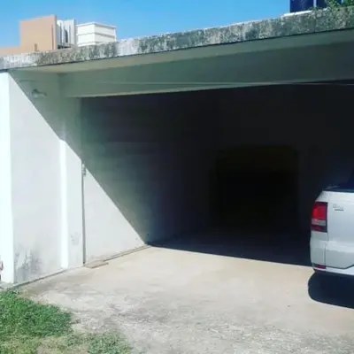 a parking garage with a car parked underneath it at DUPLEX - COCHERA CUBIERTA in Cordoba