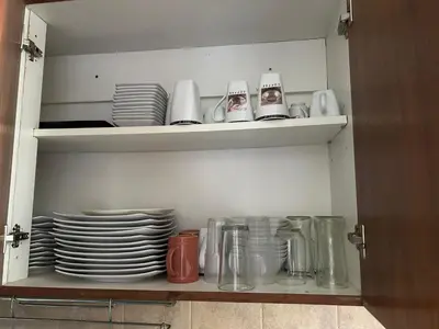 a cupboard filled with plates and cups and dishes at Departamento en Barrio Guemes in Cordoba