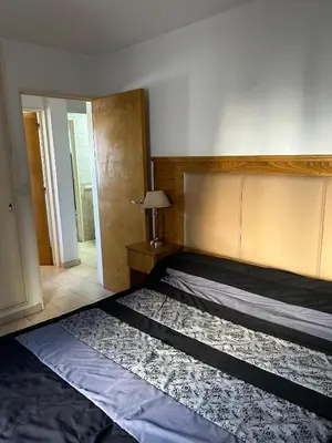 a bedroom with a large bed with a head board at Departamento en Barrio Guemes in Cordoba