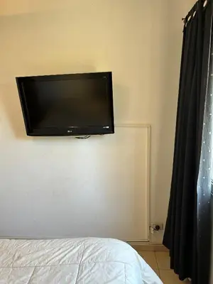 a flat screen tv on the wall of a bedroom at Departamento en Barrio Guemes in Cordoba