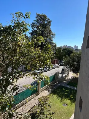 a street with cars parked in a parking lot at Departamento en Barrio Guemes in Cordoba