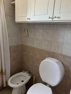 a small bathroom with a toilet and a sink at Departamento en Barrio Guemes in Cordoba