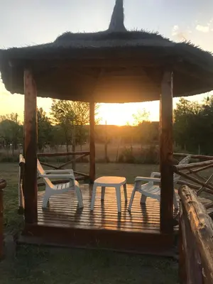a gazebo with two chairs and a table at La Soleada casas de campo in Nono