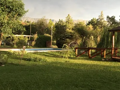 a garden with a pool and a gazebo in the grass at La Soleada casas de campo in Nono