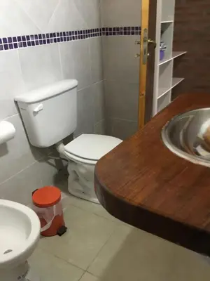 a bathroom with a toilet and a sink at La Soleada casas de campo in Nono