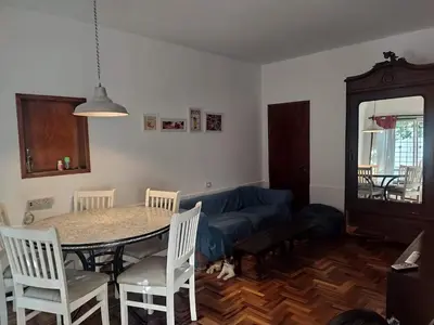 a living room with a table and a blue couch at HA! 2 Resi para estudiantes in Cordoba
