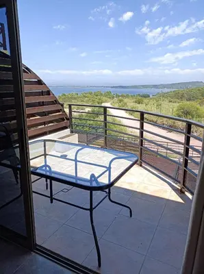 a balcony with a glass table on a balcony at Solar de Roca in Embalse
