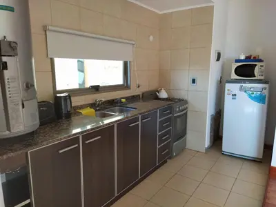 a kitchen with a sink and a refrigerator at Solar de Roca in Embalse