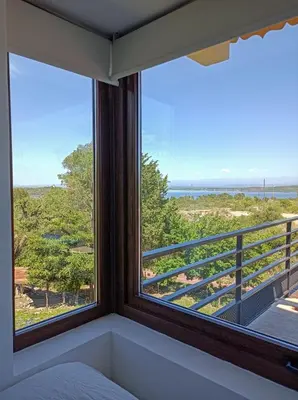 a bedroom with a window with a view of the ocean at Solar de Roca in Embalse