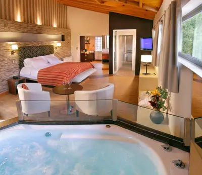 a hotel room with a tub in the middle of a room at Terrazas de Belgrano - Club de Montaña in Villa General Belgrano