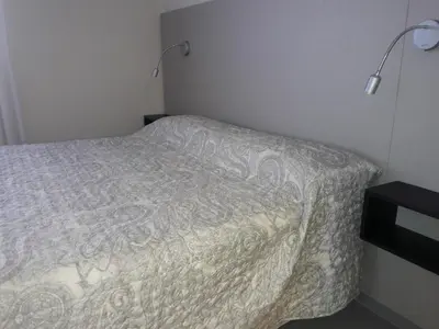 a small bedroom with a bed and a lamp at ESPACIO C Nueva Cordoba in Cordoba