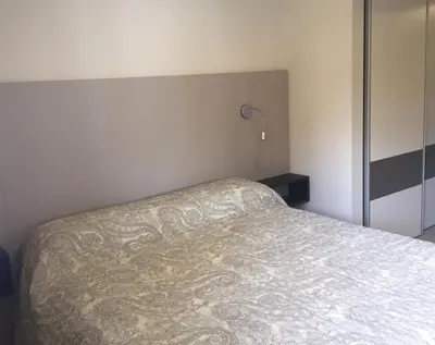 a bedroom with a bed and a lamp in it at ESPACIO C Nueva Cordoba in Cordoba