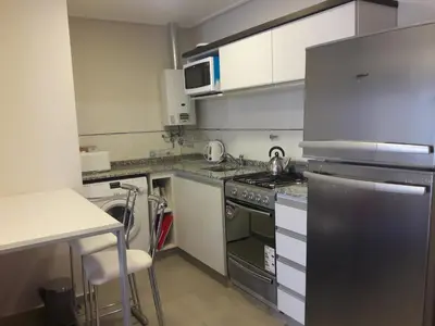 a small kitchen with a stove and a sink at ESPACIO C Nueva Cordoba in Cordoba