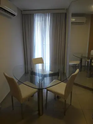 a dining room with a glass table and chairs at ESPACIO C Nueva Cordoba in Cordoba