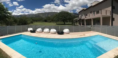 a swimming pool in front of a house at Aparts de Montaña Tavullia in Carpintería