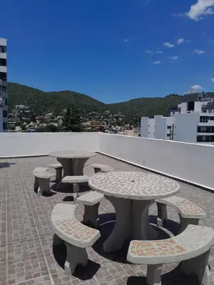 a group of tables and benches on a roof at Abuela Chela in Villa Carlos Paz
