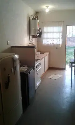 a kitchen with a stove and a refrigerator at Dpto Low Cost temporada 2026 in Mina Clavero