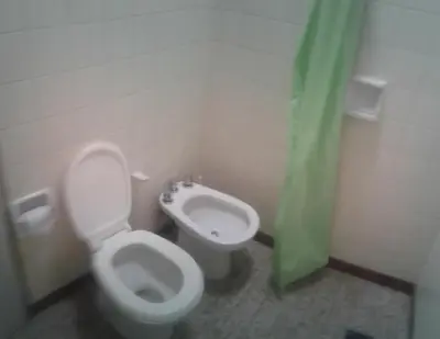 a bathroom with a toilet and a bidet at Dpto Low Cost temporada 2026 in Mina Clavero