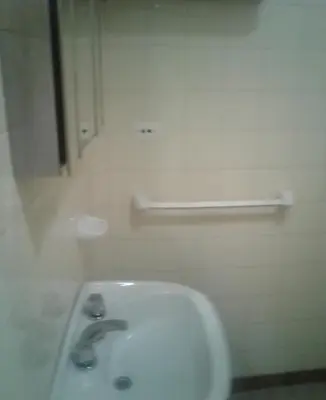 a white bathroom with a sink and a mirror at Dpto Low Cost temporada 2026 in Mina Clavero