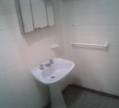 a bathroom with a white sink and a mirror at Dpto Low Cost temporada 2026 in Mina Clavero
