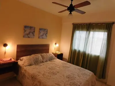 a bedroom with a bed and a ceiling fan at Villasol Temporario in Cordoba