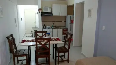 a kitchen with a table and chairs in a room at Villasol Temporario in Cordoba
