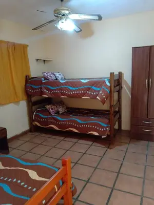 a room with two bunk beds with a ceiling at Complejo Los Sauces in Mina Clavero