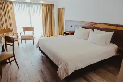 a bedroom with a large white bed in a hotel at La Urumpta Hotel, AKEN MIND in Río Cuarto