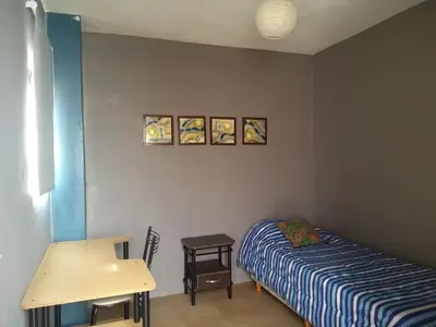 a bedroom with a bed and a desk and a table at HA! 1 Resi para estudiantes in Cordoba