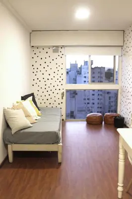 a bedroom with a bed and a large window at Depa Patio Olmos in Cordoba