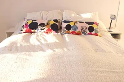 a white bed with pillows on top of it at Depa Patio Olmos in Cordoba
