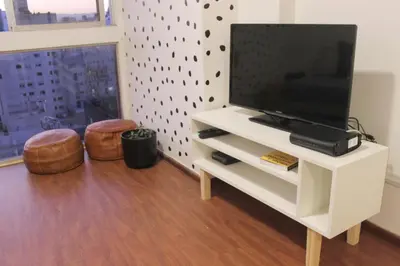 a living room with a television on a white entertainment center at Depa Patio Olmos in Cordoba
