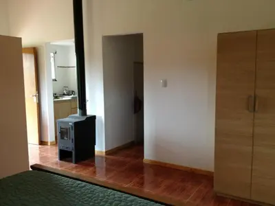 a living room with a stove in a room at Los Abedules Cabañas in Villa Alpina