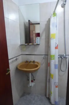a bathroom with a sink and a shower curtain at Departamento Luminoso y Ventilado Centro Viejo in Villa Carlos Paz