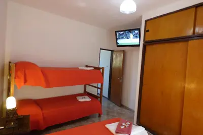 a room with two bunk beds and a flat screen tv at Departamento Luminoso y Ventilado Centro Viejo in Villa Carlos Paz