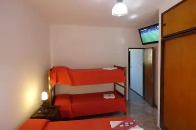 a room with two bunk beds and a flat screen tv at Departamento Luminoso y Ventilado Centro Viejo in Villa Carlos Paz