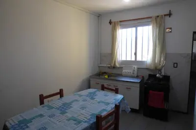 a small kitchen with a table and a window at Departamento Luminoso y Ventilado Centro Viejo in Villa Carlos Paz
