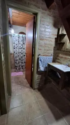 a bathroom with a shower with a sink and a table at Los Teros in Tanti